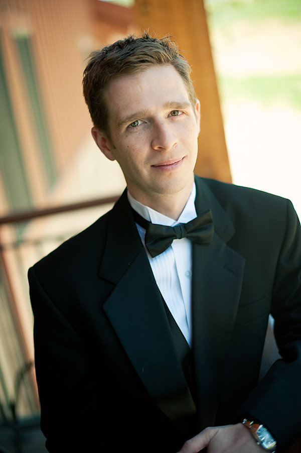 The handsome groom wearing a black tuxedo - photo by Houston based wedding photographer Adam Nyholt